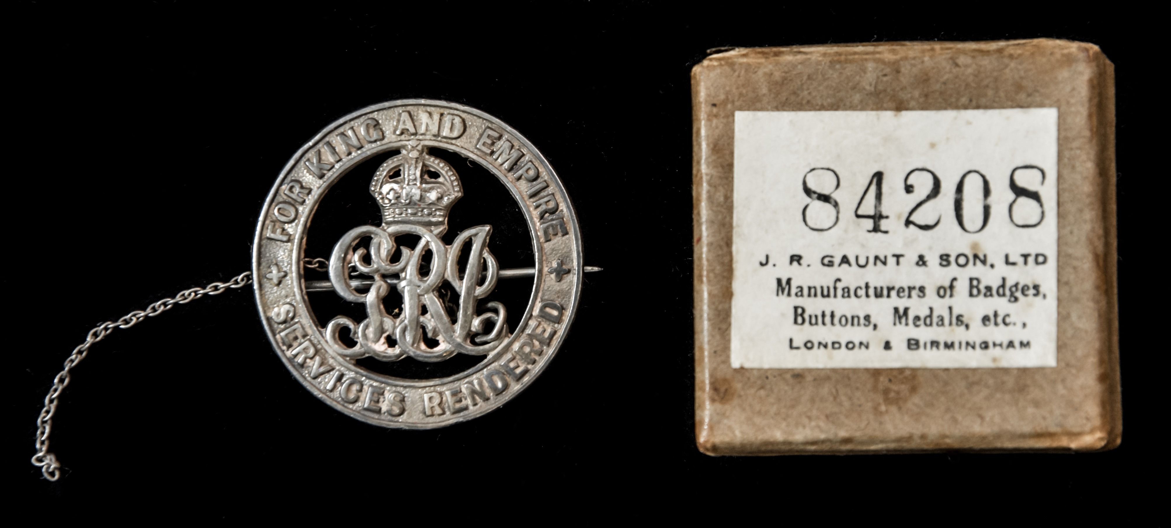 Silver War Badge, reverse numbered ‘84208’, together with a partial safety chain, and housed in i...